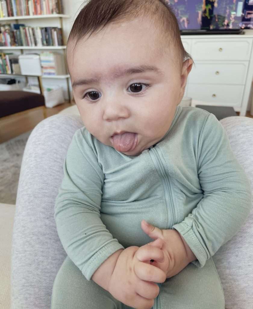 Domenico clasping his hands and tongue thrusting
